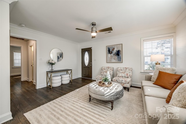 living area featuring visible vents, baseboards, ceiling fan, wood finished floors, and crown molding