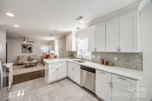 kitchen featuring a sink, visible vents, open floor plan, decorative backsplash, and dishwasher