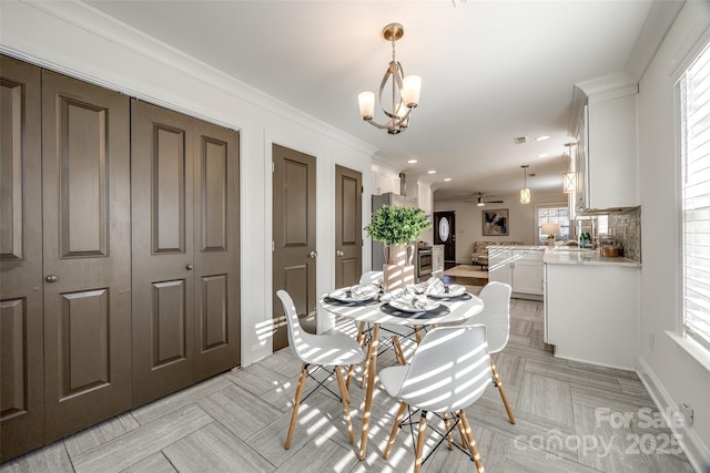 dining room featuring ornamental molding, recessed lighting, and ceiling fan with notable chandelier