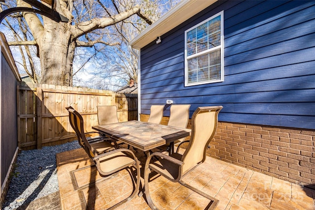 view of patio with fence and outdoor dining area