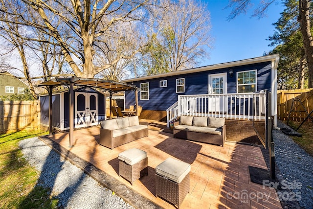 rear view of house with a patio area, a fenced backyard, outdoor lounge area, and a pergola