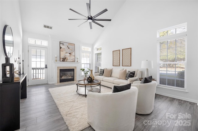 living room with ceiling fan, dark wood-type flooring, and high vaulted ceiling