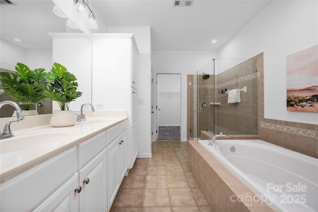 bathroom with vanity, tile patterned floors, and plus walk in shower