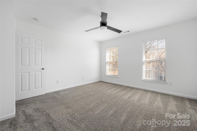 carpeted spare room featuring ceiling fan