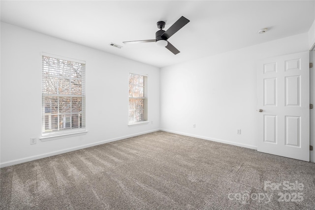 carpeted spare room featuring ceiling fan