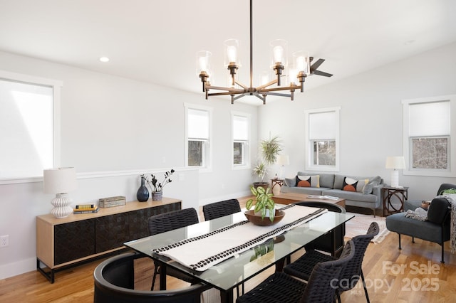 dining space featuring light hardwood / wood-style flooring and an inviting chandelier