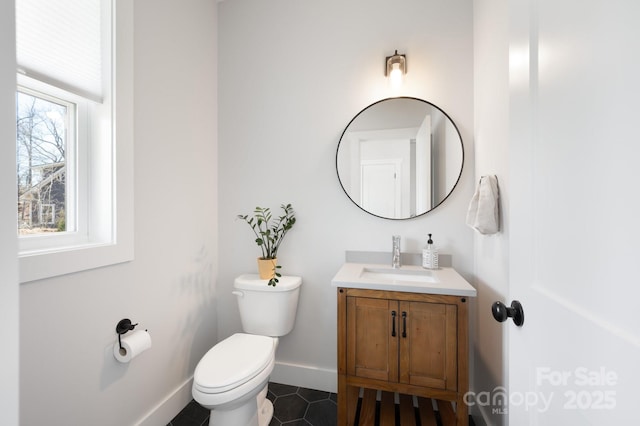 bathroom featuring tile patterned floors, vanity, and toilet