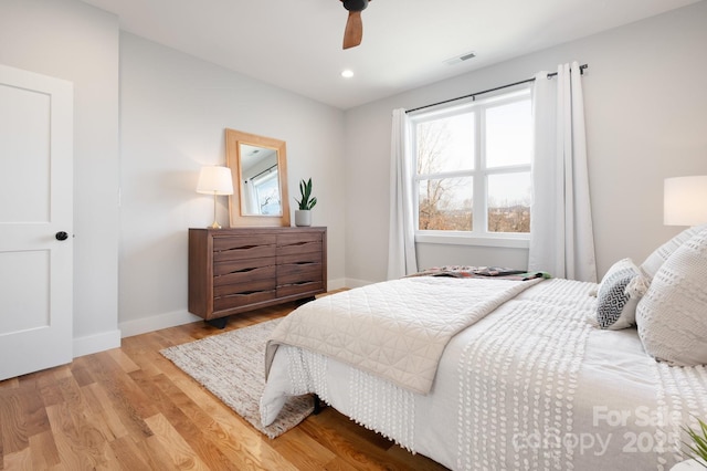 bedroom with ceiling fan and light hardwood / wood-style floors