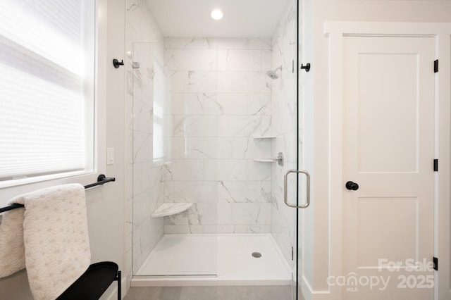 bathroom with a shower with shower door