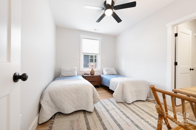 bedroom with ceiling fan and light wood-type flooring