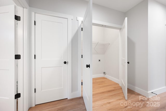 clothes washing area with wood-type flooring and electric dryer hookup