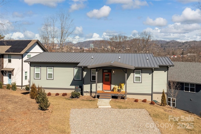 view of front of property with covered porch and a mountain view