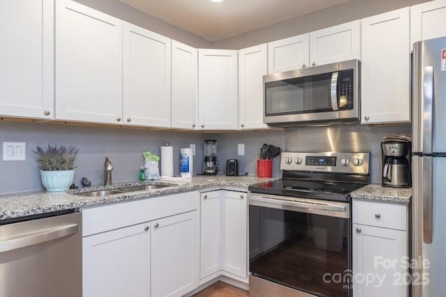 kitchen featuring white cabinetry, appliances with stainless steel finishes, and sink