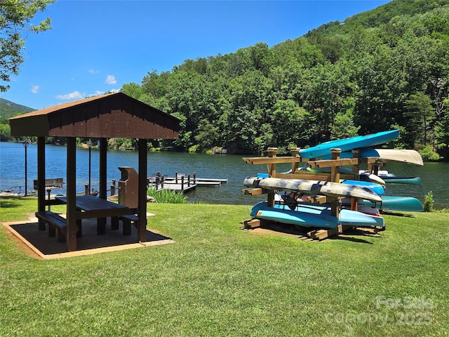 dock area with a water view and a yard