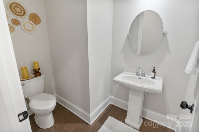 bathroom featuring hardwood / wood-style floors and toilet