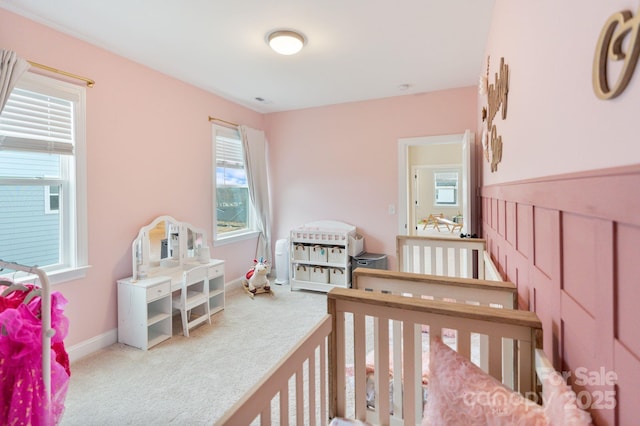 bedroom featuring carpet floors and multiple windows