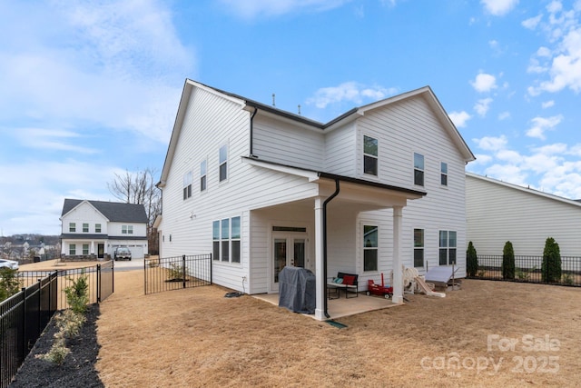 back of property featuring french doors, a patio, and a lawn