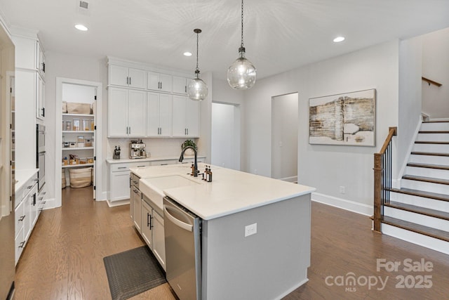 4159 Millstream Rd, Denver, NC 28037 - kitchen featuring white cabinetry, appliances with stainless steel finishes, light countertops, a sink, and dark wood-style floors