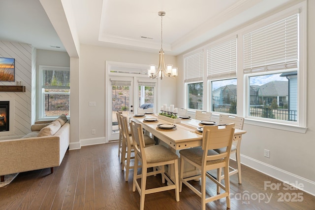 4159 Millstream Rd, Denver, NC 28037 - dining area featuring dark wood finished floors, a large fireplace, visible vents, a raised ceiling, and a notable chandelier
