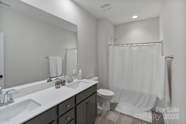 4159 Millstream Rd, Denver, NC 28037 - bathroom featuring wood finished floors, visible vents, toilet, and a sink