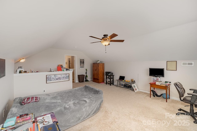 interior space with baseboards, visible vents, a ceiling fan, lofted ceiling, and carpet flooring