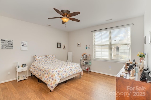 bedroom featuring visible vents, ceiling fan, light wood-style flooring, and baseboards