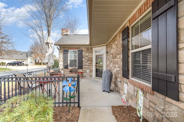 view of patio featuring covered porch and a grill