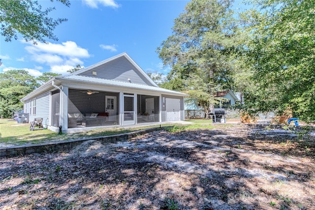 rear view of property featuring a sunroom