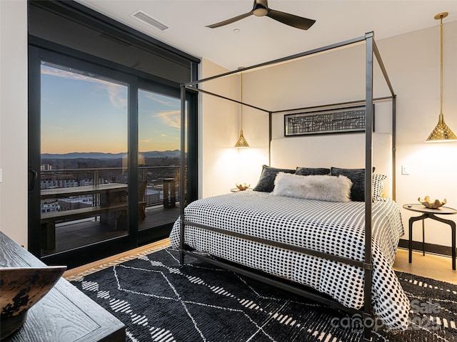 bedroom with hardwood / wood-style floors and ceiling fan