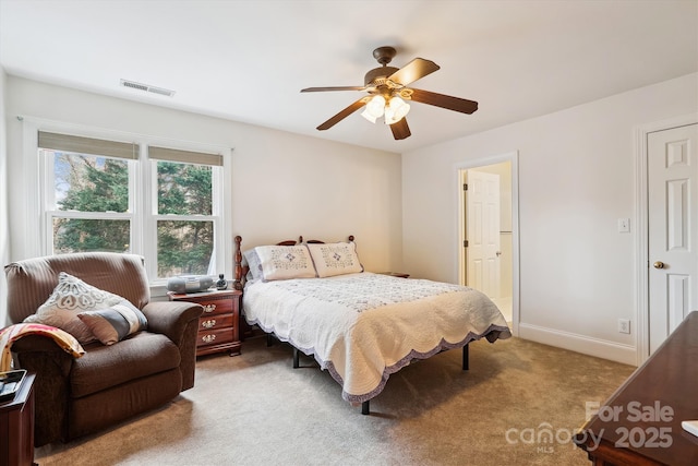 carpeted bedroom with a ceiling fan, visible vents, and baseboards