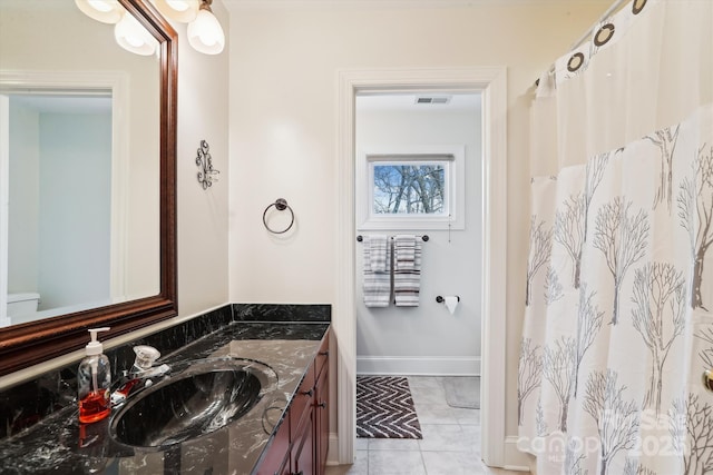 full bathroom with tile patterned flooring, baseboards, and vanity