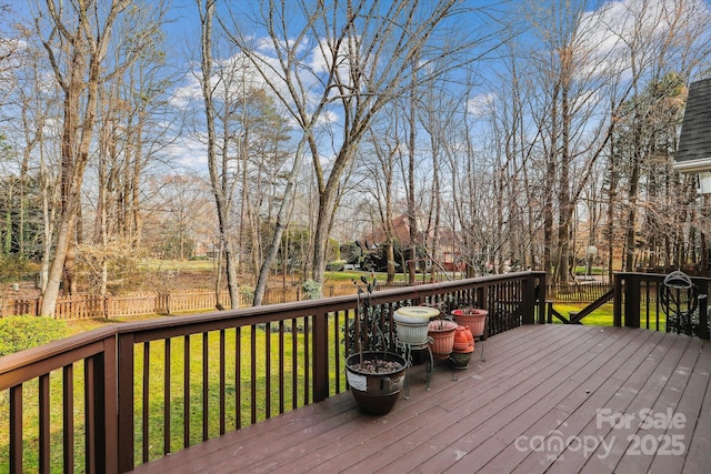 deck featuring a yard and fence