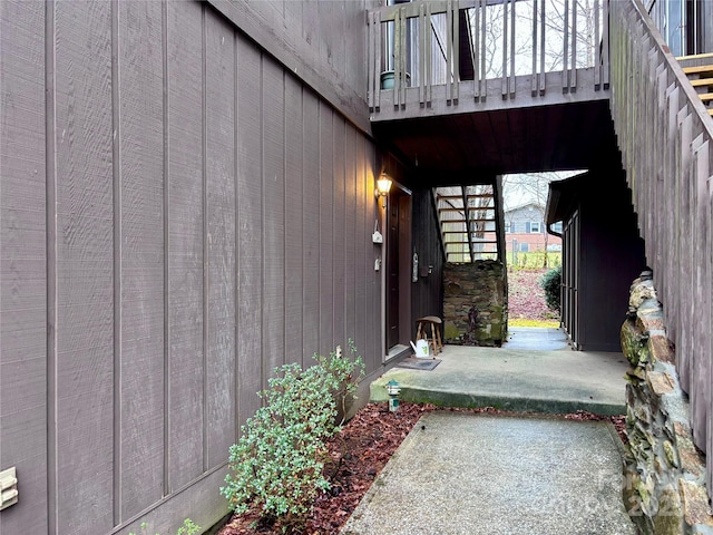 view of exterior entry with a patio area