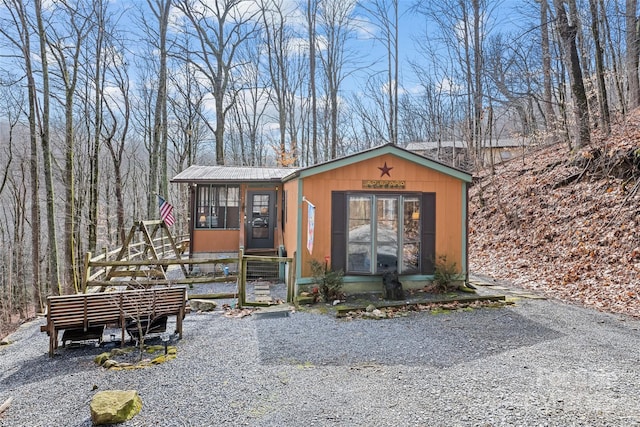 view of outdoor structure featuring a sunroom