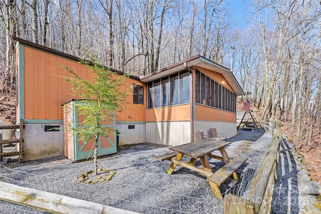 view of side of property with a sunroom