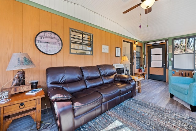 living room with ceiling fan, wood-type flooring, and vaulted ceiling