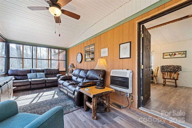 living room with hardwood / wood-style flooring, ceiling fan, lofted ceiling, and heating unit