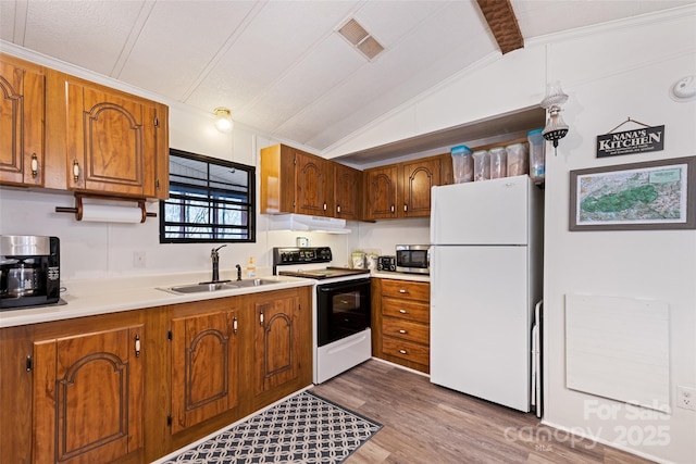 kitchen with vaulted ceiling, wood-type flooring, sink, white fridge, and electric range