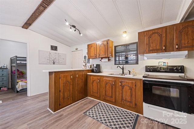 kitchen featuring sink, vaulted ceiling with beams, electric range oven, light wood-type flooring, and kitchen peninsula