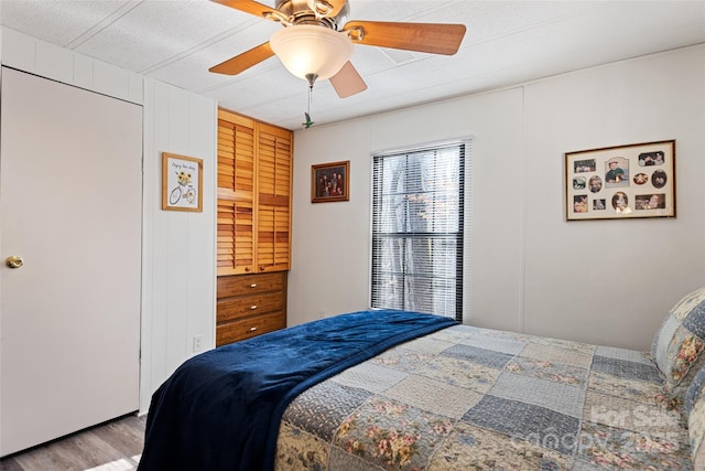 bedroom with ceiling fan and light wood-type flooring