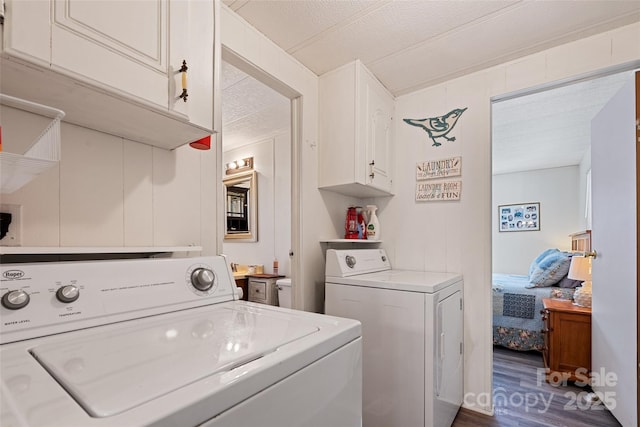 washroom with cabinets, dark hardwood / wood-style floors, and washer and dryer