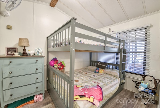 bedroom with crown molding and hardwood / wood-style floors