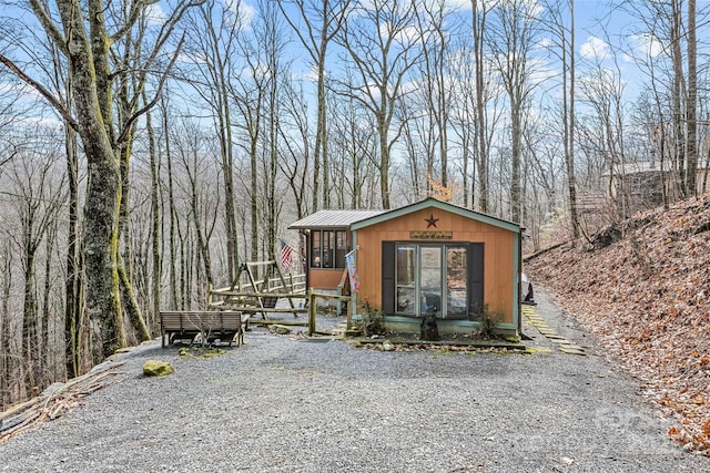 view of outbuilding featuring a sunroom