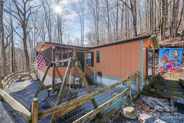 view of jungle gym featuring a sunroom