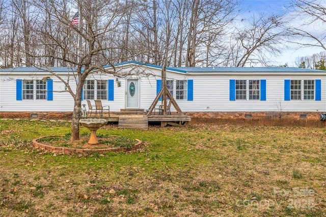 manufactured / mobile home featuring metal roof, a front lawn, and crawl space