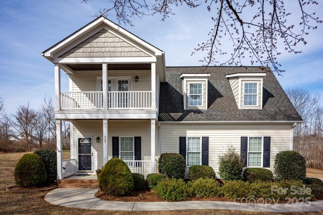 662 Georgie St, Troutman, NC 28166 - view of front of property with a balcony, covered porch, and a shingled roof