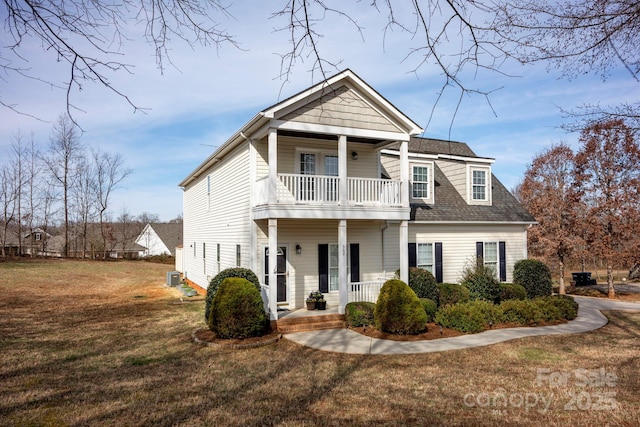 662 Georgie St, Troutman, NC 28166 - view of front of property featuring a balcony, covered porch, a front yard, and roof with shingles
