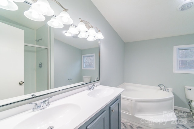 full bathroom featuring vanity, separate shower and tub, and toilet