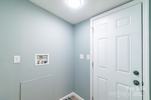 clothes washing area featuring washer hookup and a textured ceiling