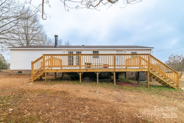 rear view of house featuring a wooden deck